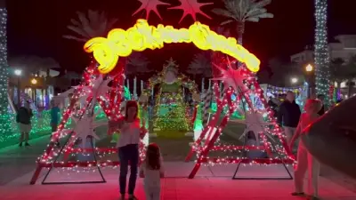 On Jacksonville Beach, lifeguard chairs are lit up alongside Christmas trees