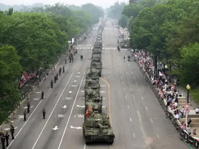 Military parade rolls through DC as ‘No Kings’ protesters across US decry Trump